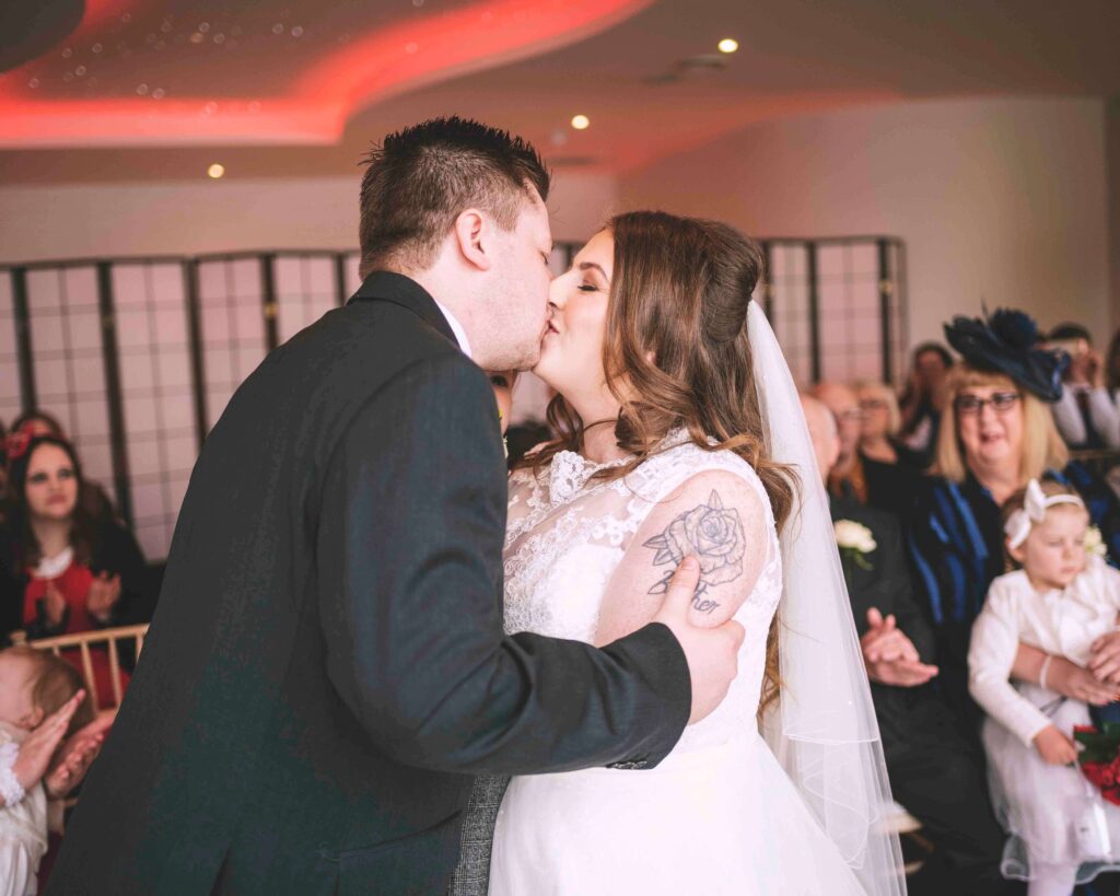 The first kiss at Sandy Cove Hotel wedding ceremony