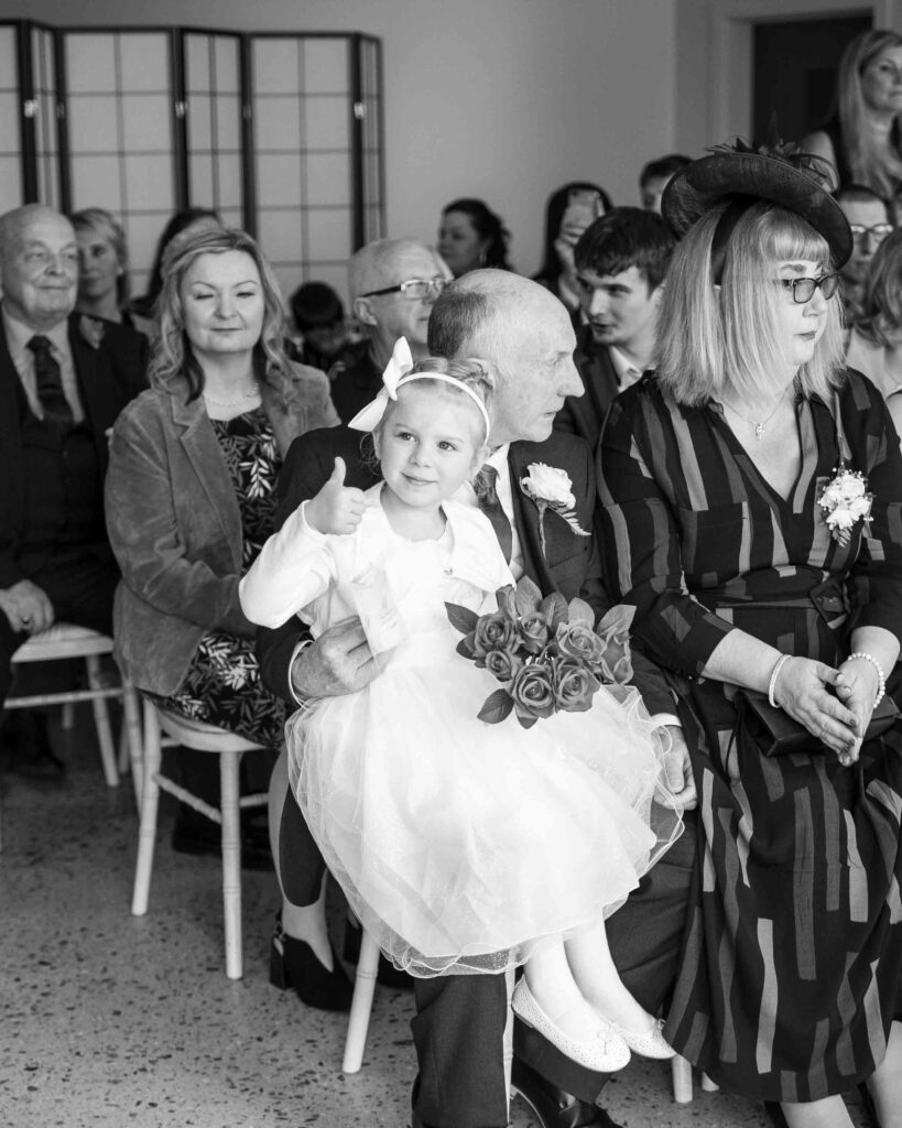 Flower girl giving a thumbs up at the Sandy Cove Hotel wedding